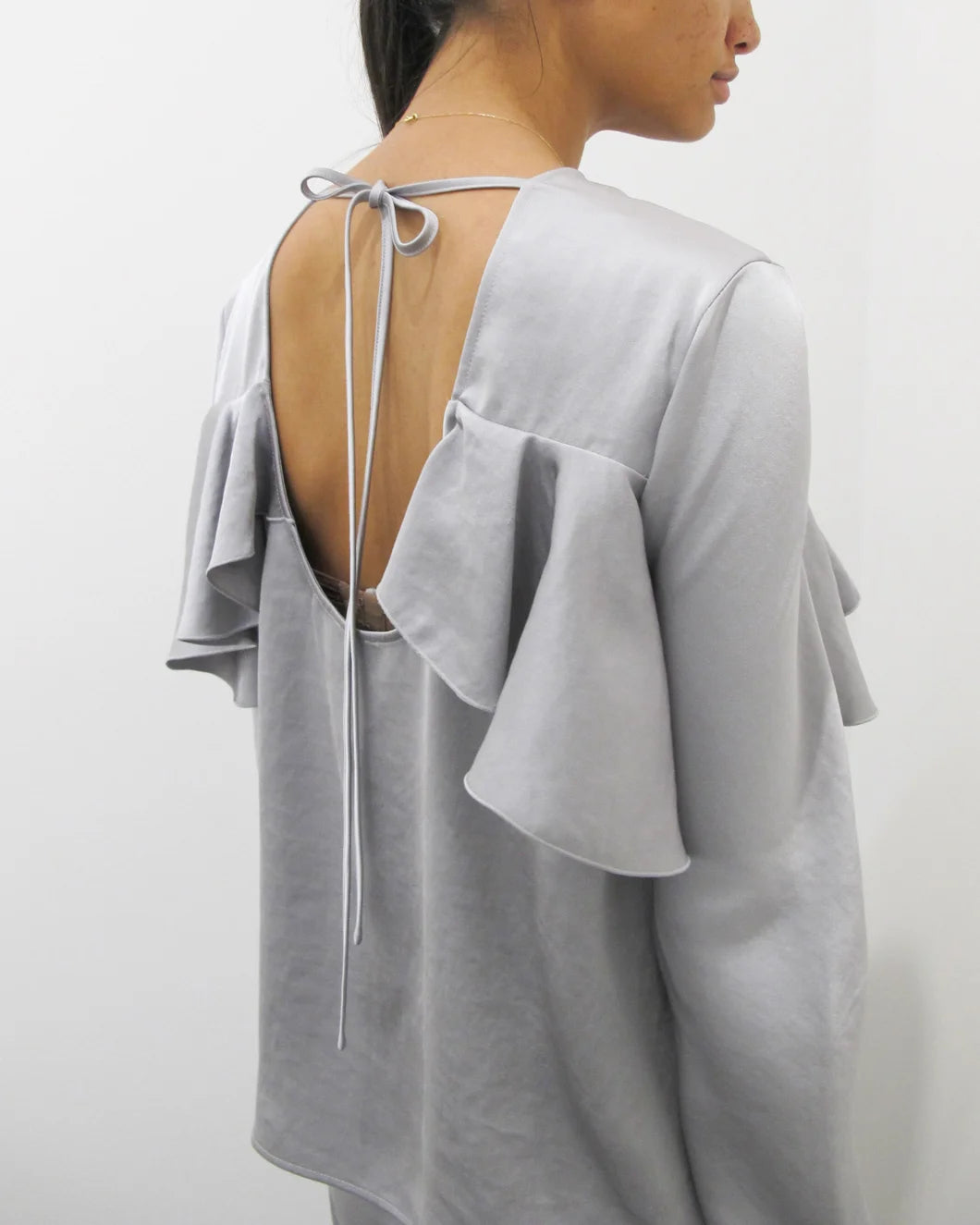 GANNI Double Viscose Satin Long Sleeve Ruffle Top grey on figure back detail