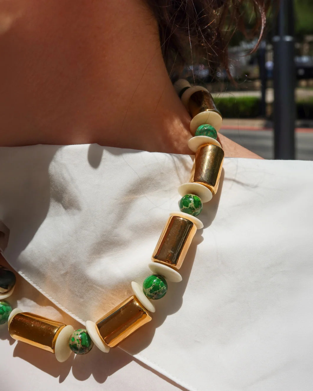HER NEW TRIBE Karat and Sea Sediment Stacked Necklace on figure front detail
