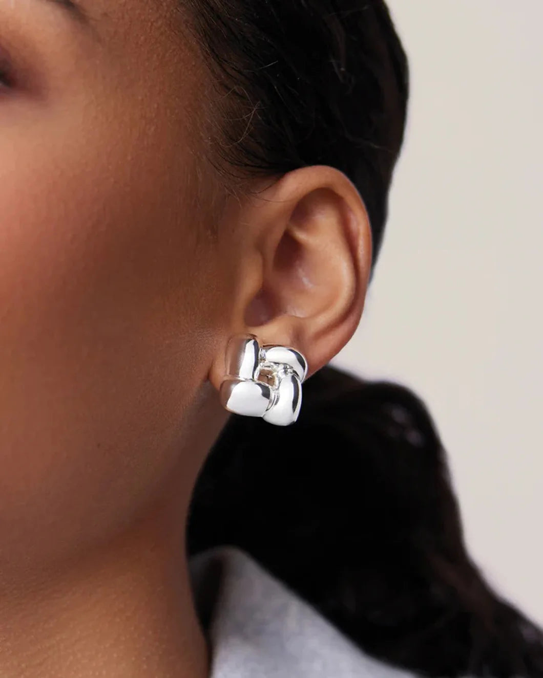 JENNY BIRD small woven earrings silver on figure front 1