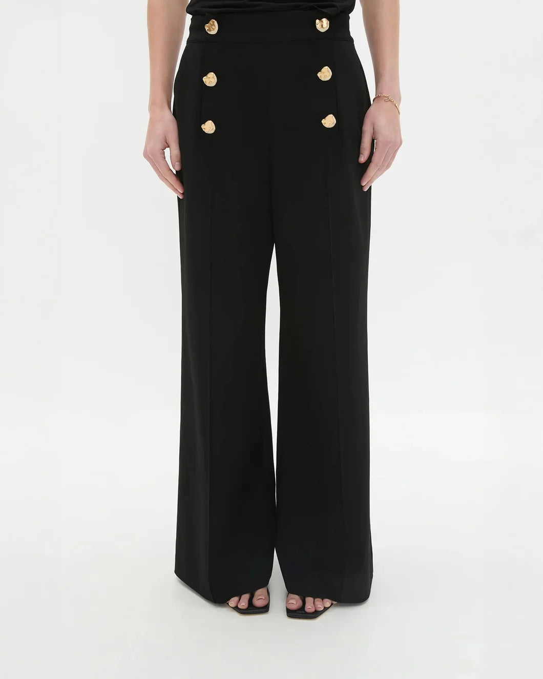 aje Gabrielle Pant black with gold button detail on model front close up