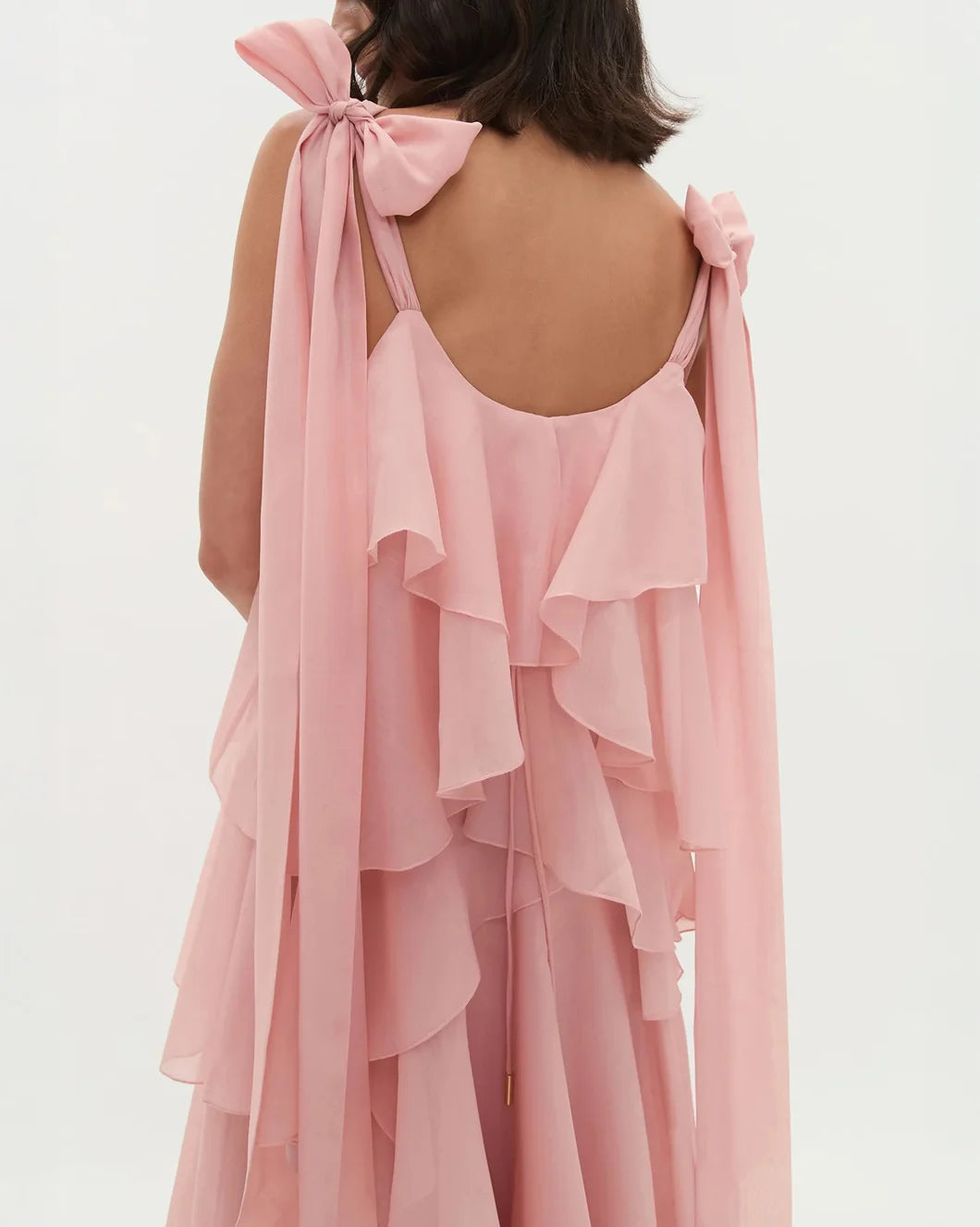 aje Gracie Maxi tiered ruffle Dress with tie straps in muted rose pink on model back view