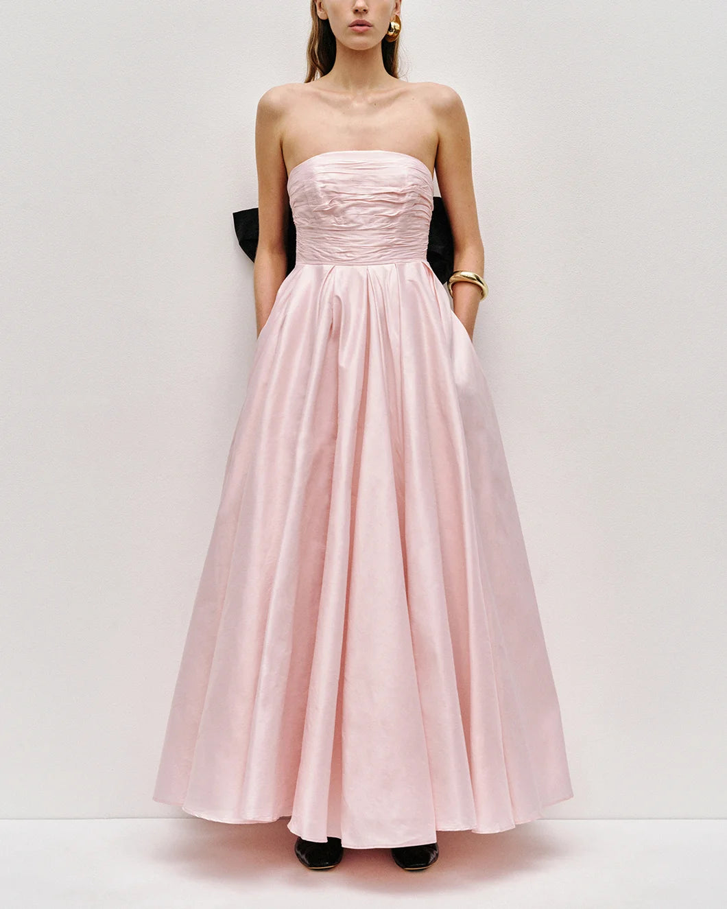 Thea strapless pink tint gown with large black bow at the back by aje shown from the front view