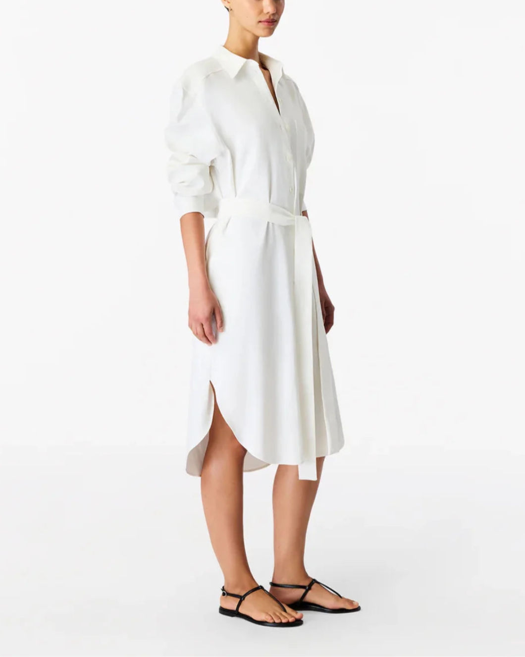Woman wearing a white dress side view on a white background