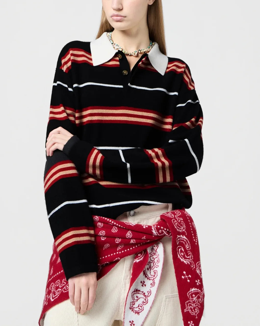 long sleeved striped rugby shirt in black, red, and cream cashmere by guest in residence on model front detail view