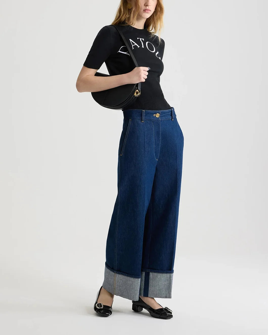 patou black jaquard knit top in eco friendly cotton blend with white logo on model side