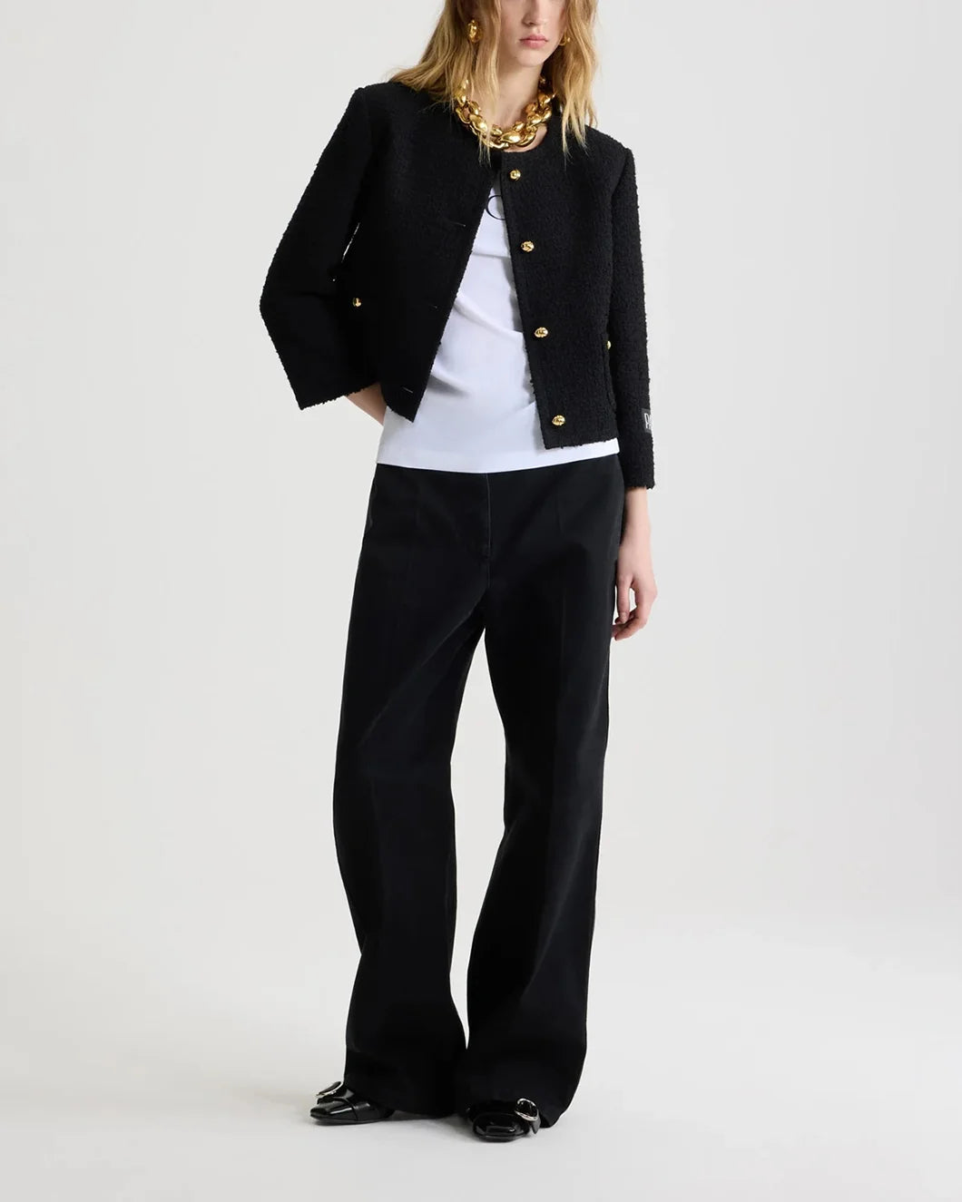 patou short collarless jacket in sustainable wool blend tweed in black on model front