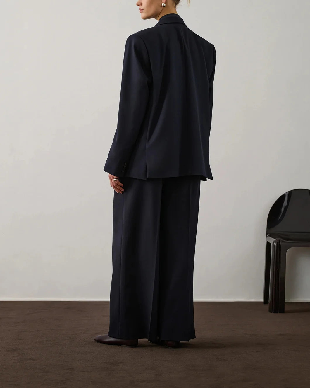Back view of Soeur Frejus Pants showing elastic waistband and tailored structure with a blazer
