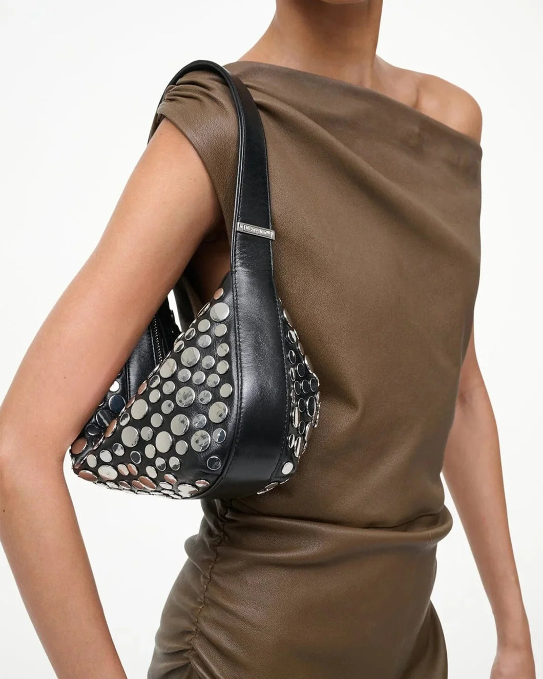 staud demy shoulder bag in black with silver rivets on figure