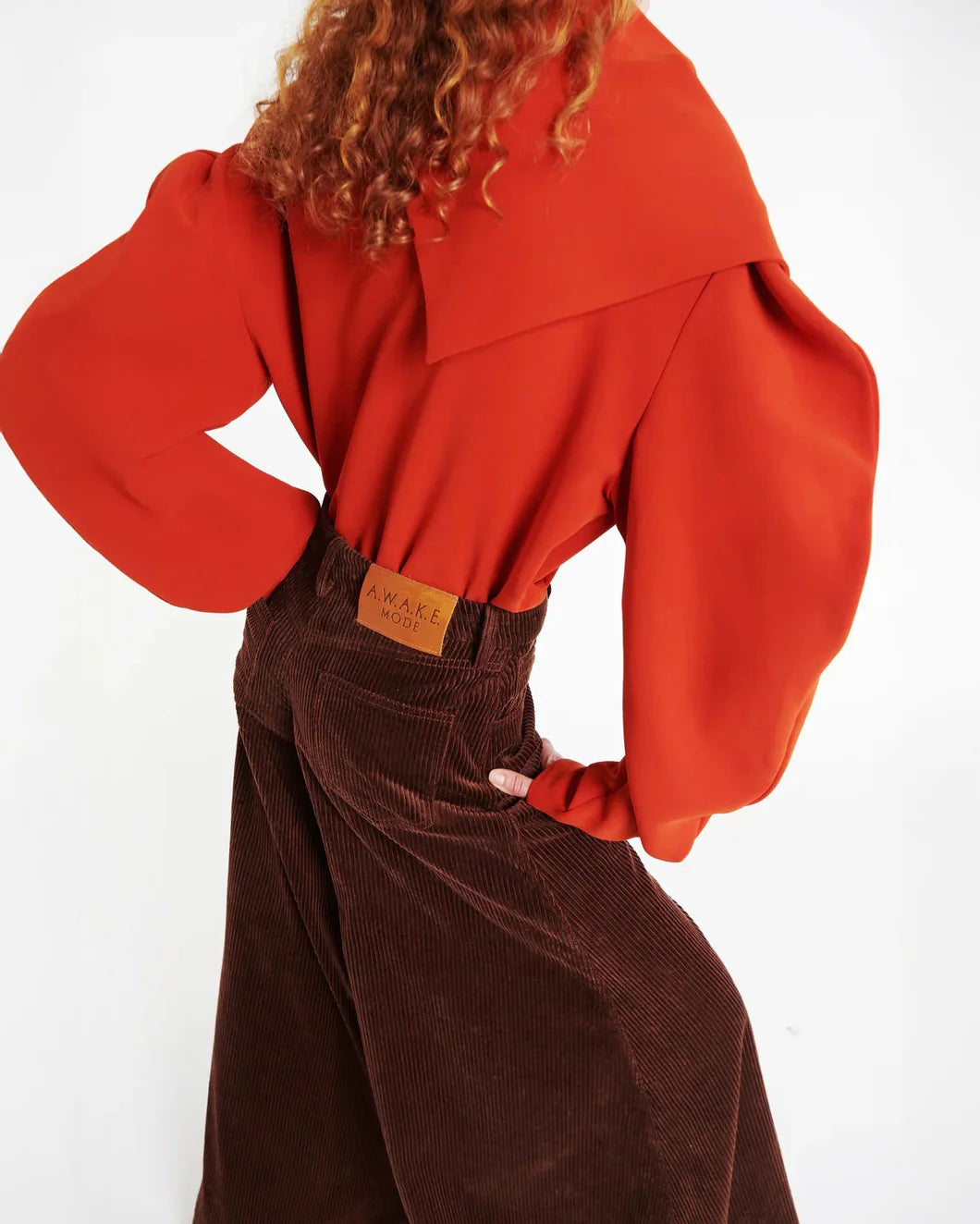 AWAKE MODE draped collar top terracotta  on figure side