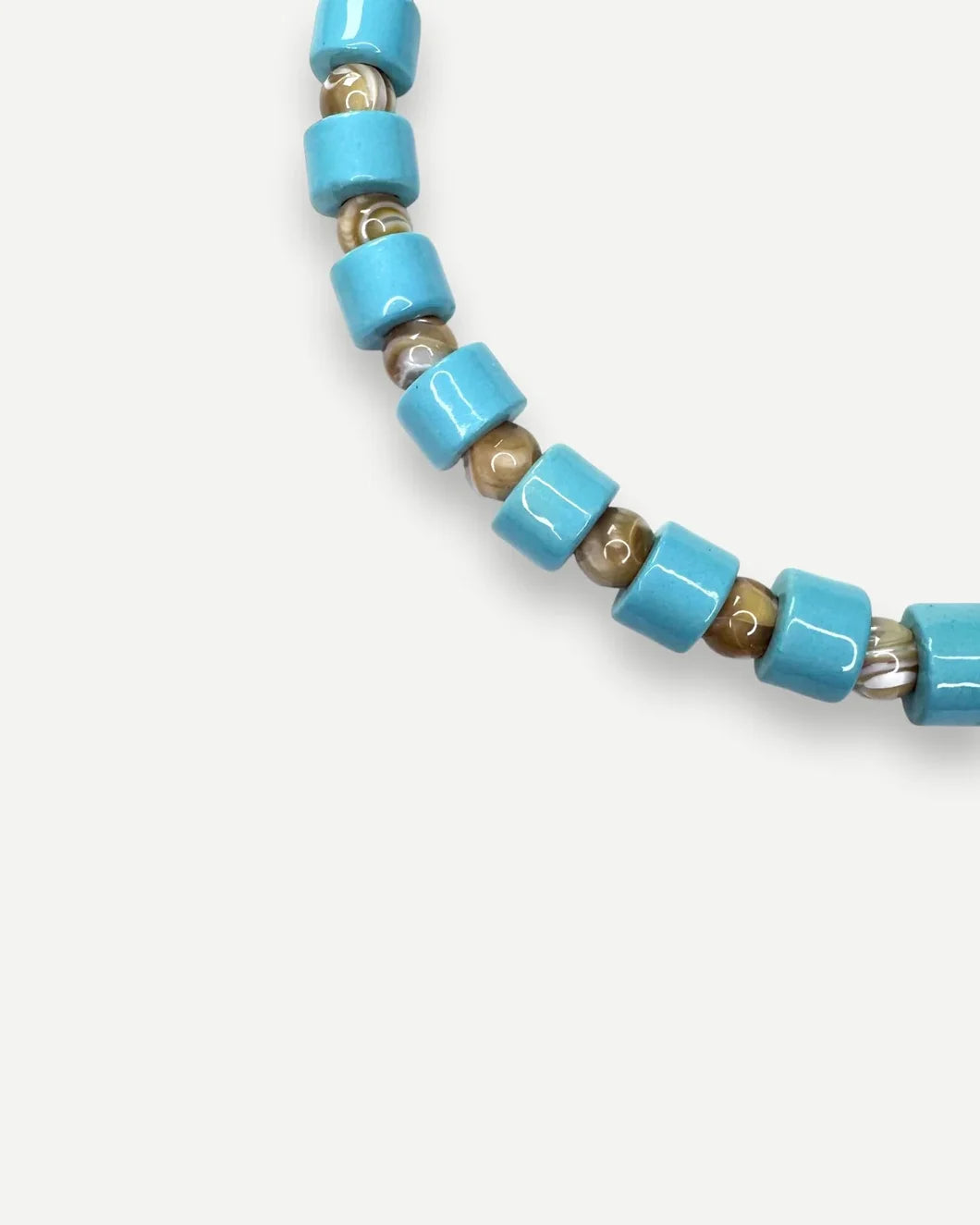 HER NEW TRIBE pool and conch mother of peaqrl sundry bead two front detail