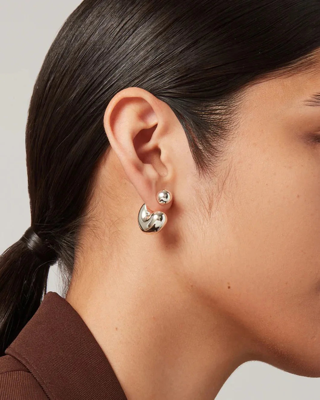 JENNY BIRD tome hoop earrings silver on figure front