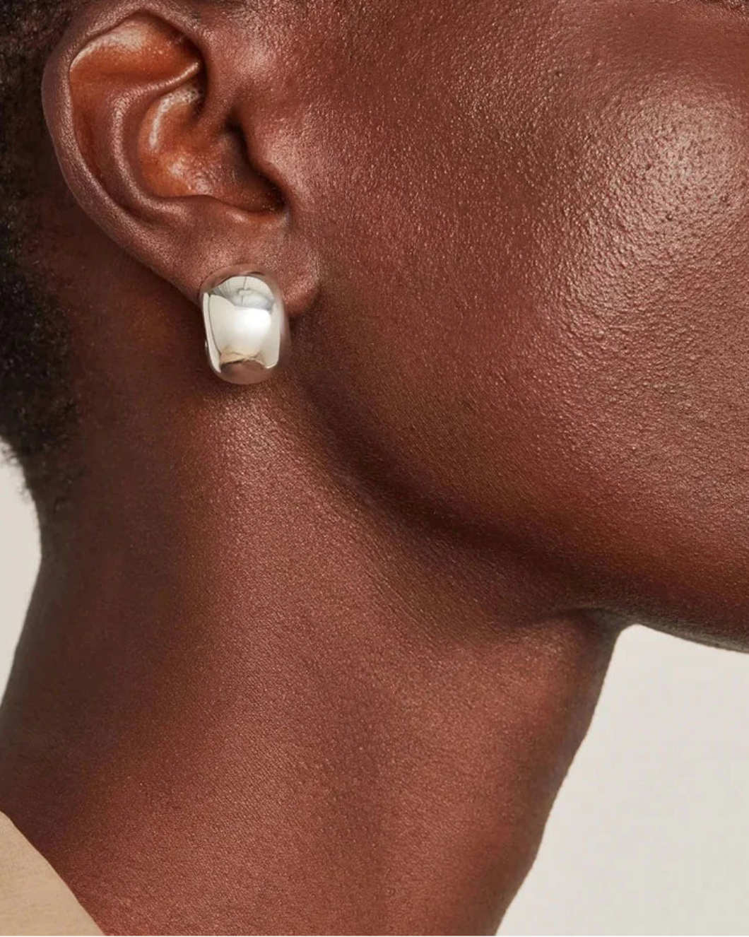 JENNY BIRD small gemma hoop earrings silver on figure side 
