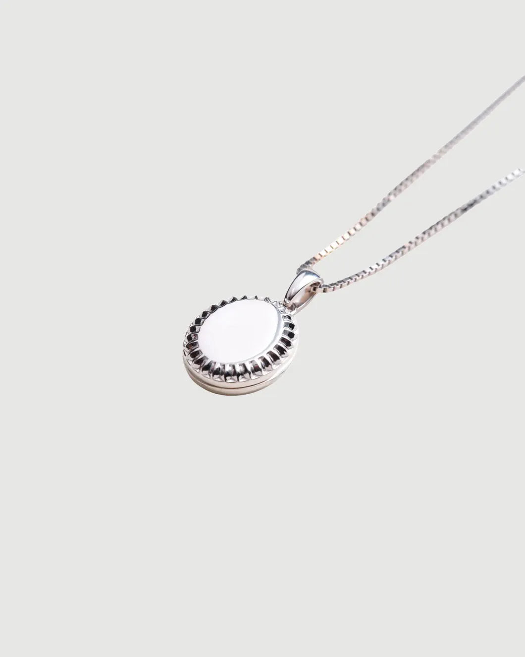 THEIR sutton oval locket silver isolated