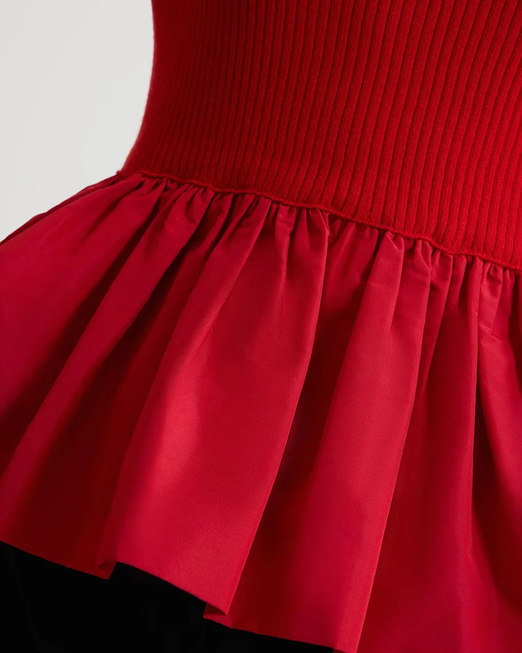 patou Ruffle Hem Ribbed Jumper in Wool and Faille in elixir red on model side detail view