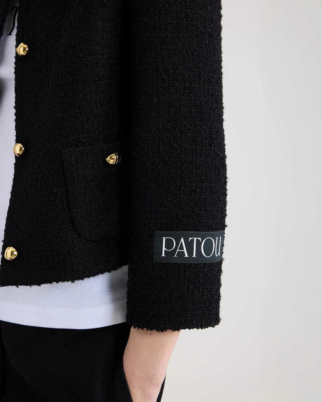 patou short collarless jacket in sustainable wool blend tweed in black on model cuff detail