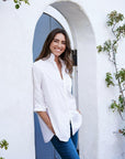 Effortless look for women - long button down in white paired with denim jean.